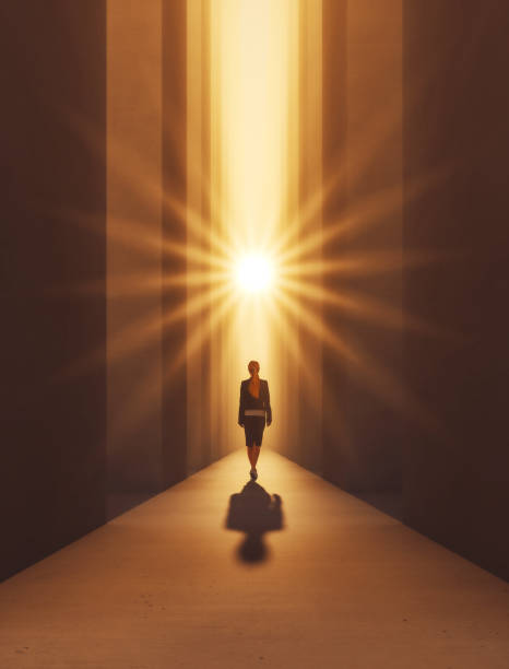 a woman leaving towards a ray of light